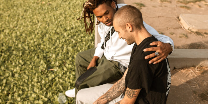 man comforting another male